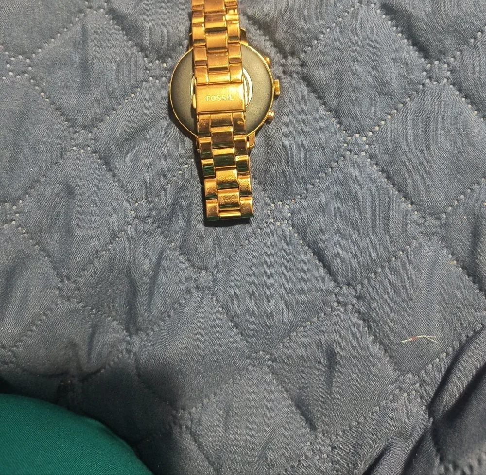 Gold Smartwatch with Black Charging Cable
